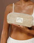 Person holding a textured Beige Terry Towelling Avocado Zinc Pouch