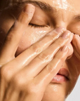 iS Clinical Cleansing Complex – model cleansing her face