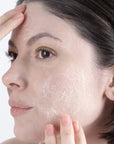 Close-up of a woman's face with visible skin texture and blemishes using Universkin Le Gel Exfoliating Foaming Gel Cleanser