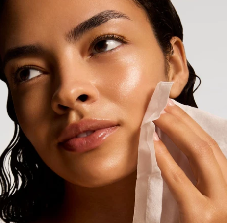 iS Clinical Active Peel System – model using a peel pad on her face