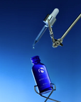 iS Clinical Active Serum – bottle and dropper on blue background