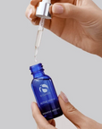 iS Clinical Active Serum – dropper being drawn from the bottle