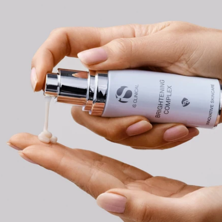iS Clinical Brightening Complex – cream dispensed onto a fingertip