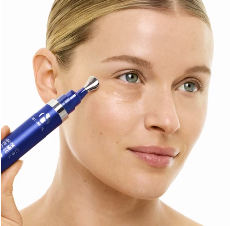 iS Clinical GeneXC Firming Eye Gel – model applying the gel under her eye