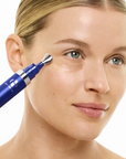 iS Clinical GeneXC Firming Eye Gel – model applying the gel under her eye
